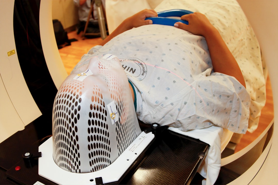 Patient undergoing radiation therapy with custom mask.